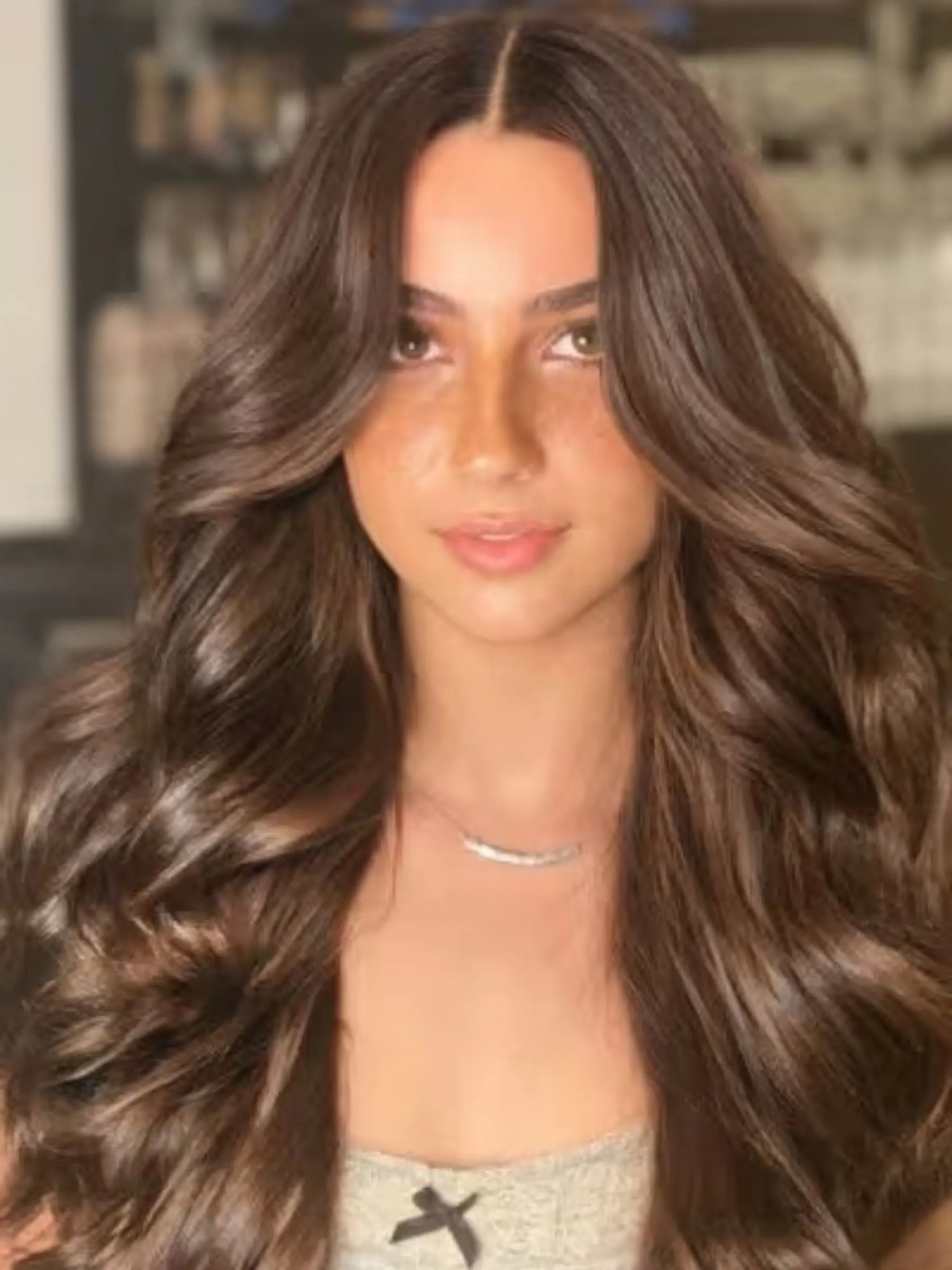 Long, thick brunette waves with colour-matched hair extensions applied at Erin Morgan Hair Subiaco