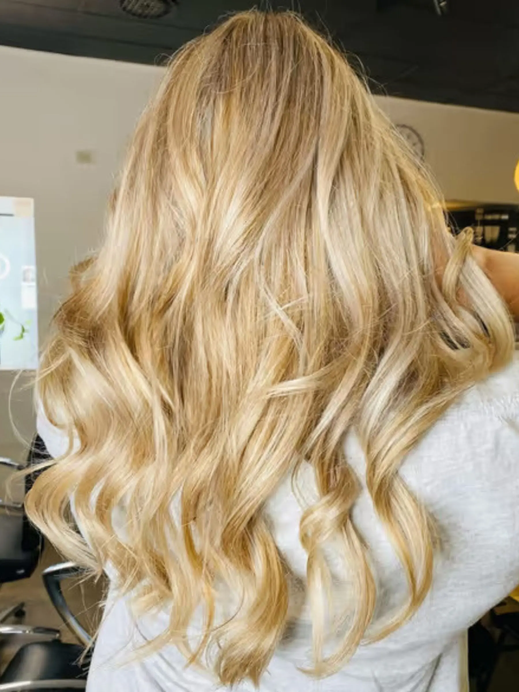 Glossy blonde lengths after an organic bond repair and conditioning treatment at Erin Morgan Hair Subiaco