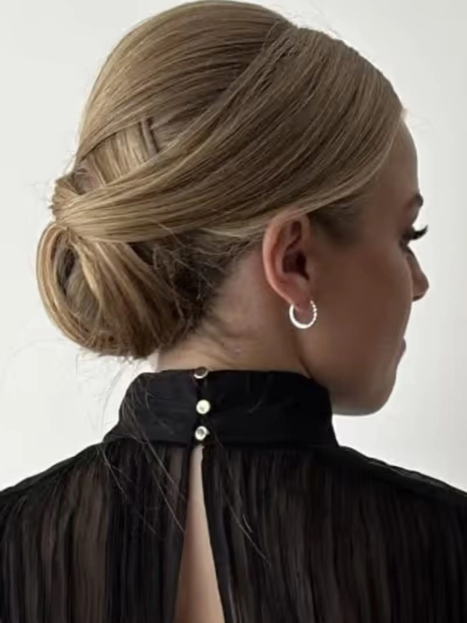 Low twisted chignon upstyle finished for a wedding at Erin Morgan Hair Subiaco